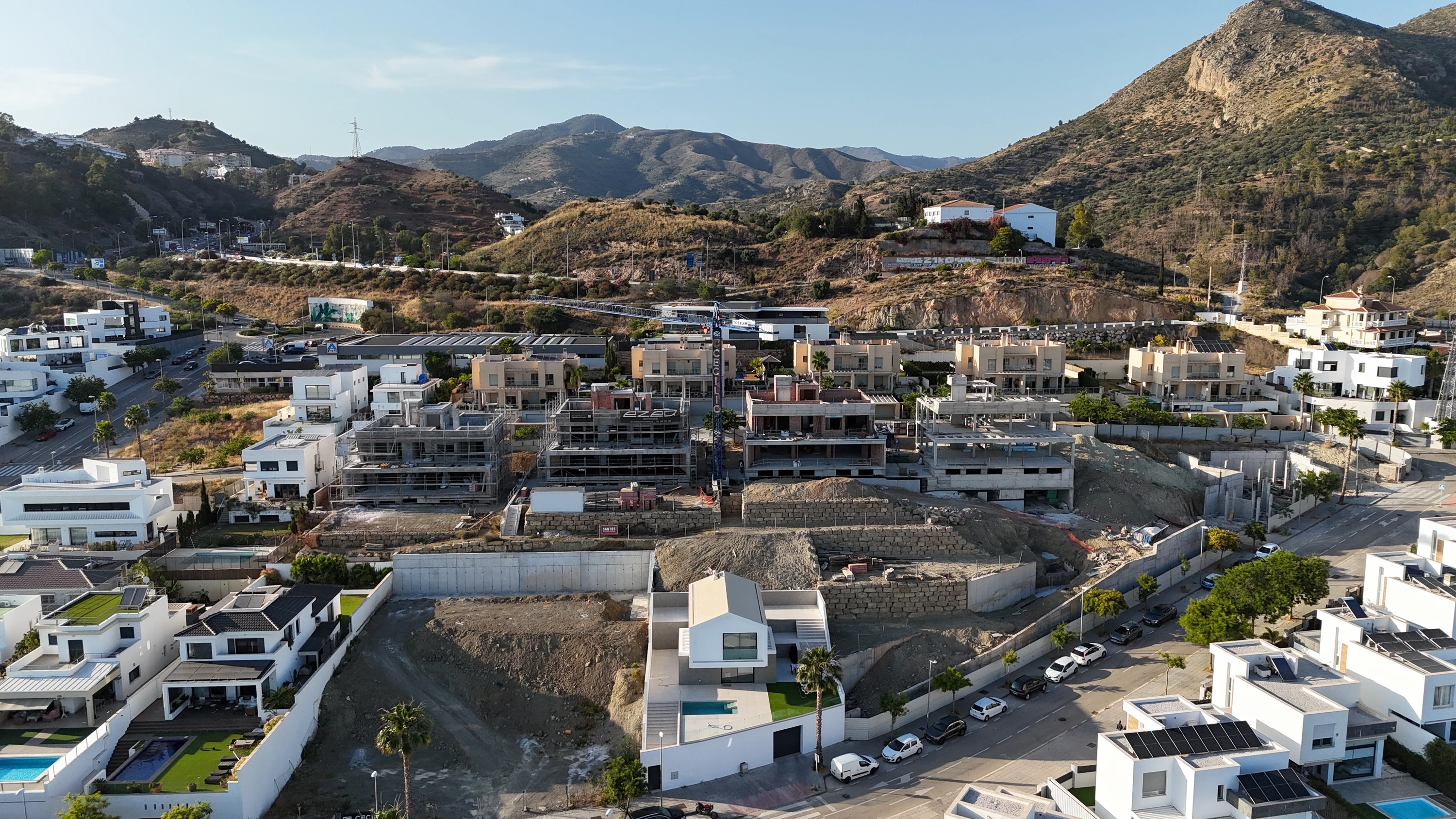 Villas Hacienda Paredes Málaga — drone aerial view under construction, mountain backdrop